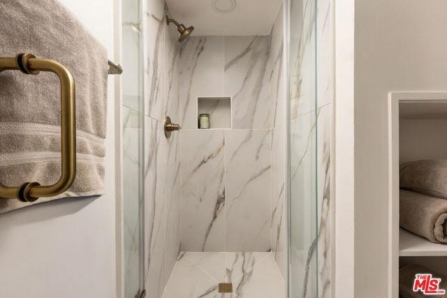 Marble shower with brass fixtures