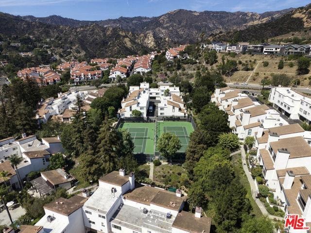 Community tennis courts aerial view with mountain backdrop